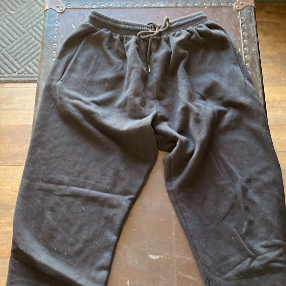 Black sweatpants with cinched ankles + drawstring at waist
